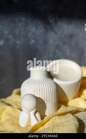 Homemade white ceramic candles on grey background. Stock Photo