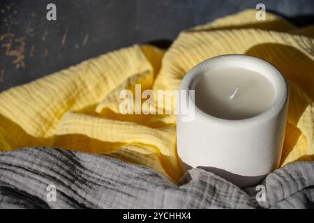 Homemade white ceramic candles on grey background. Stock Photo