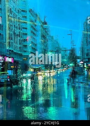 Gran Via street viewed through a wet glass, night view. Madrid, Spain. Stock Photo