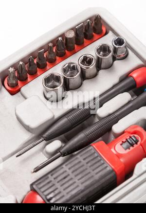Open toolbox with screwdriver, heads and bit Stock Photo