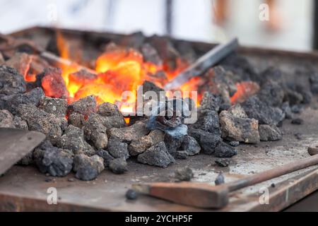 Forge fire in blacksmith's where iron tools are crafted Stock Photo