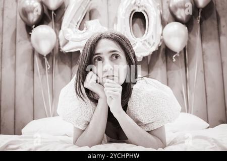 Thoughtful serious anxious mature woman feeling worried about problems of getting old. Middle aged grey haired lady looking away.Monochrome black and Stock Photo