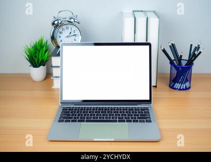 Space for copying your text. Laptop with blank screen on white table and office supplies on wooden background. Workspace and copy space. Desk with off Stock Photo