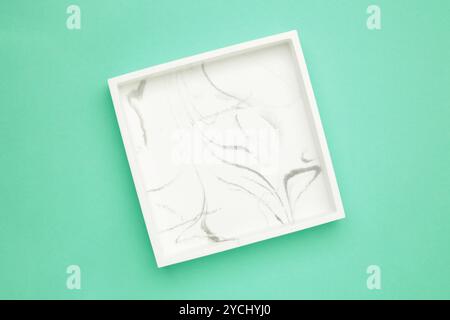 Ceramic square tray on a mint background. Top view Stock Photo