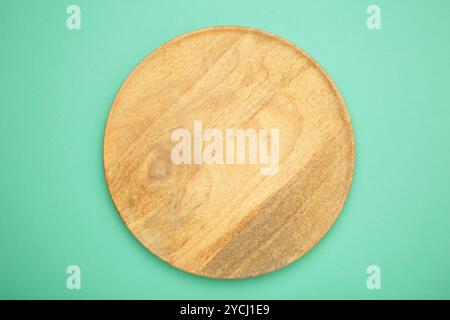 Empty wooden tray on mint background. Rectangular wooden dish. Top view Stock Photo