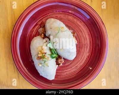 cepelins stuffed with minced meat on a red plate Stock Photo