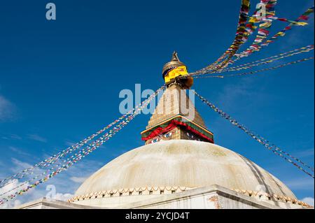 Buddhist Shrine Boudhanath Stupa with pray flags over blue sky. Nepal Stock Photo