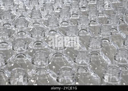 A lot of empty clean glass bottles. Close up shot, selective focus, abstract background for recycling or packaging. Stock Photo