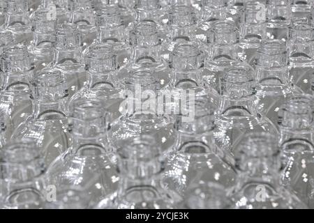 A lot of empty clean glass bottles. Close up shot, selective focus, abstract background for recycling or packaging. Stock Photo