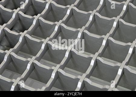 Three-dimensional steel grid with square cells, non-slip floor covering for industrial facilities. Abstract geometrical metalworking background. Stock Photo