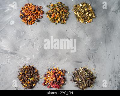 Assorted dry tea of different varieties with additives on a gray background. Space for text. High quality photo Stock Photo