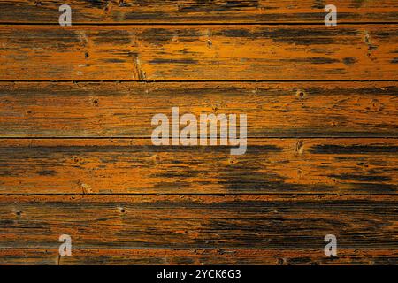 Rustic wooden wall made from horizontal planks with a worn, weathered texture, distressed look of the wood Stock Photo