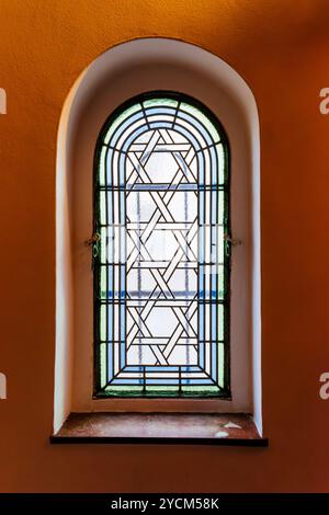 Stained glass window with ornament of Magen David, hexagram. Ceremonial hall of the Prague Jewish Burial Society was built for the last service to the Stock Photo