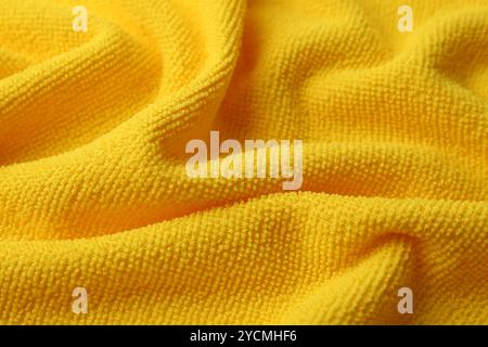 Clean yellow microfiber cloth as background, closeup Stock Photo