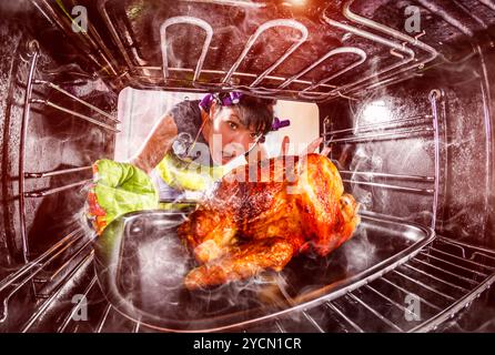 Funny Housewife overlooked roast chicken in the oven, so she had scorched , view from the inside of the oven. Housewife perplexed and angry. Loser is Stock Photo