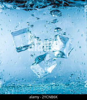 Ice cubes falling under water Stock Photo