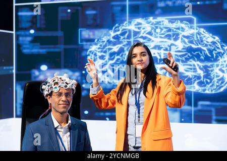 Portrait of specialist speaking at tech event, explaining impact of neural implants and AI technology. Neuroscience researchers present risks and threats associated with conscience transferring Stock Photo