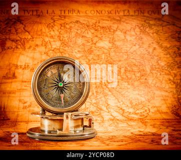 Compass lies on an ancient world map Stock Photo - Alamy