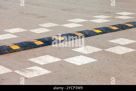 Traffic safety speed bump on an asphalt road Stock Photo