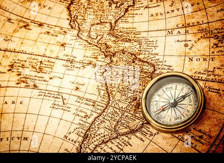 Vintage compass lies on an ancient world map Stock Photo - Alamy