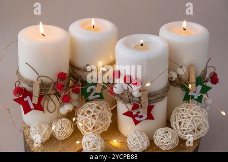 Four Advent candles calendar with Christmas zero waste decorations. Holiday preparation copy space for text. Catholic traditions of Christmas countdown new year winter holidays  Stock Photo