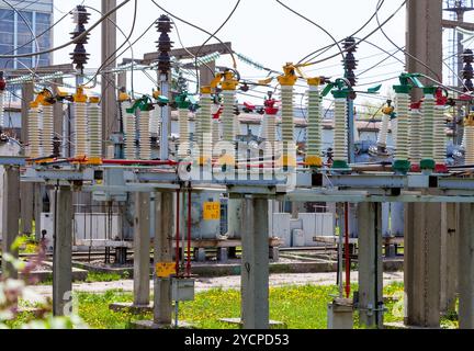 High voltage circuit breaker in a power substation in sunny day Stock Photo