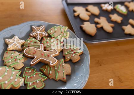 Festive gingerbread cookies decorated on plate, ready for Christmas celebration, at home Stock Photo