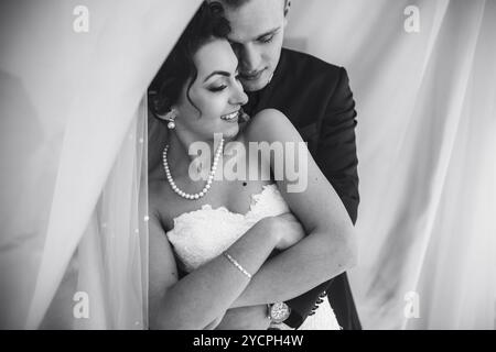 Beautiful European bridal couple in the hotel room Stock Photo