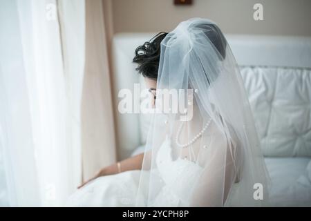 Beautiful European bridal couple in the hotel room Stock Photo