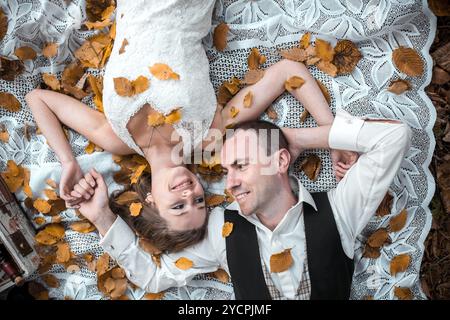 Wedding couple lying under a tree Stock Photo