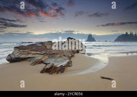 Windy morning along the Narooma cloastline.  In the foreground, one of the many rock formations around here at Glasshouse Rocks. Stock Photo