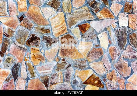 Fragment of a grey stone wall as background Stock Photo