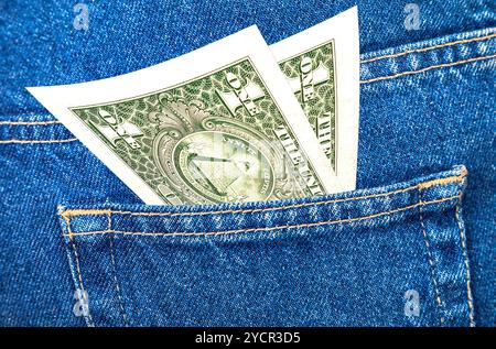 Banknotes of one american dollar sticking out of the back jeans pocket Stock Photo