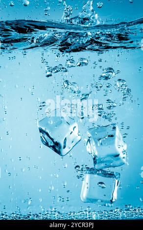 Ice cubes falling under water Stock Photo
