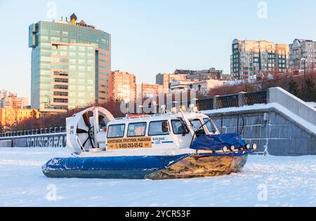 Hovercraft transporter at the Volga embankment in winter sunny day ...