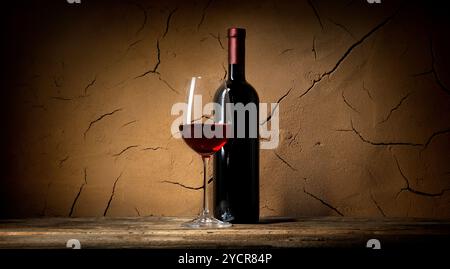 Clay wall in cellar and red wine Stock Photo