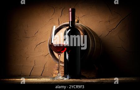 Old red wine in cellar near clay wall Stock Photo