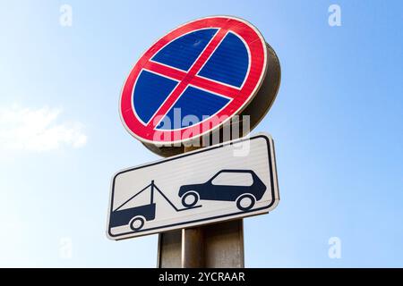 Traffic sign prohibiting parking. Evacuation on tow truck Stock Photo