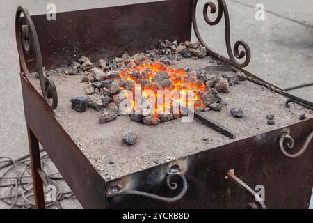 Forge fire in blacksmith's where iron tools are crafted Stock Photo