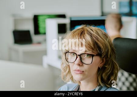 Young Woman In Eyeglasses Working On Computer Stock Photo