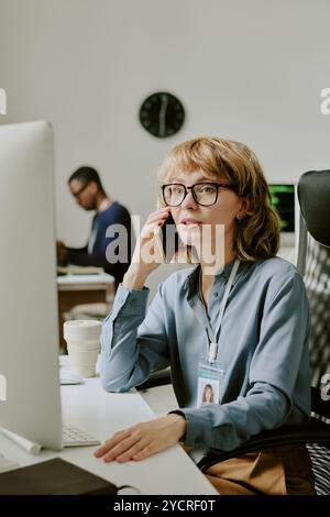 Female Specialist Talking On Phone Stock Photo