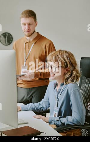 Young Specialists Coworking in Modern Office Stock Photo