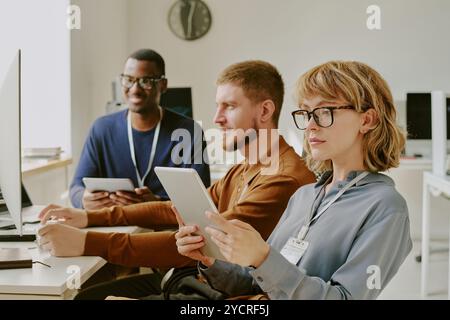 Female Specialist Checking Data On Digital Tablet Stock Photo