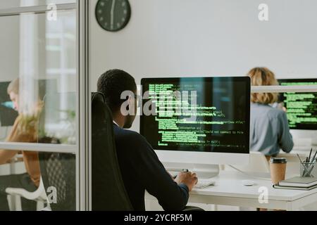 Unrecognizable Black Man Coding on Computer Stock Photo