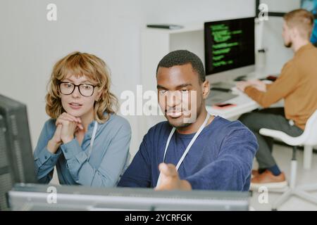 Man and Woman Working Together in Modern Office Stock Photo
