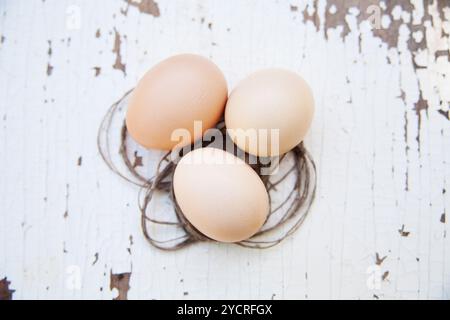 Eggs lie on an old white table Stock Photo