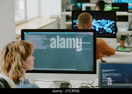 Female IT Specialist Programming On Computer In Office Stock Photo