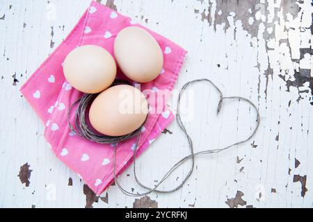 Top view of three eggs on rose napkin Stock Photo
