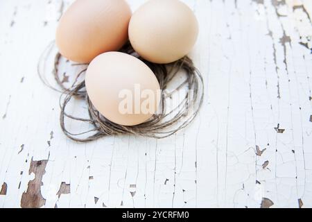 Eggs lie on an old white table Stock Photo