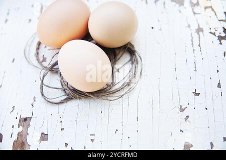 Eggs lie on an old white table Stock Photo